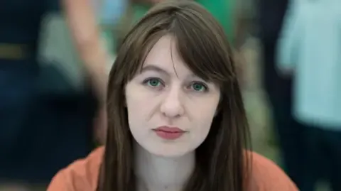 Irish author Sally Rooney claims she will not travel to the UK over potential arrest